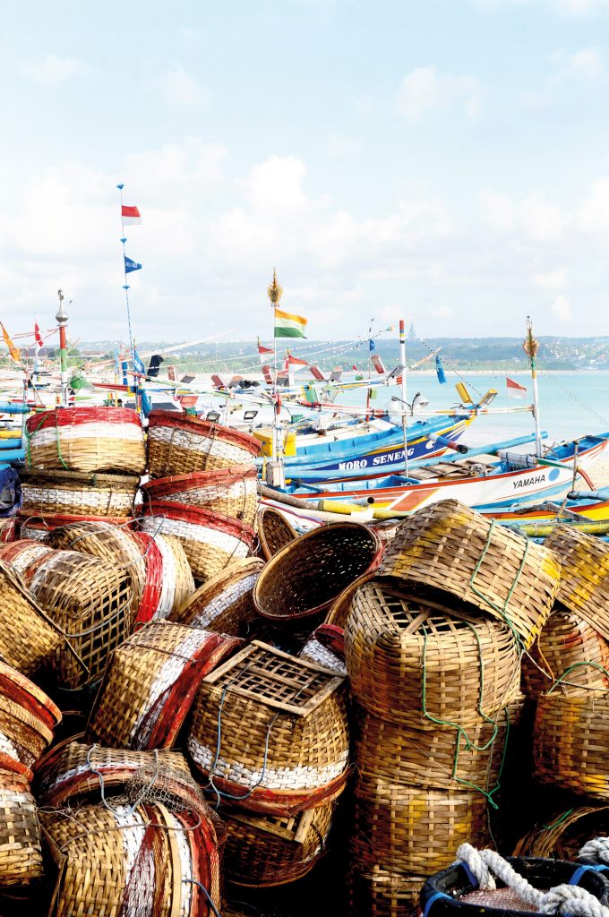 Fish containers have emptied on the beach of Kedonganan village near Jimbaran, and are transported to the beachfront Kedonganan fish market and other wet markets as well as many, many restaurants and hotels around South Bali.