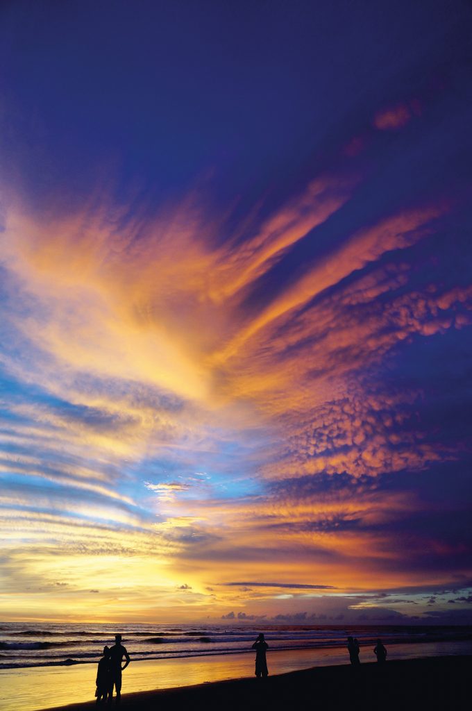 When the sun slowly and gracefully sinks into the horizon, every pair of eyes would look at the sky. Sunsets in Bali always entertain us.