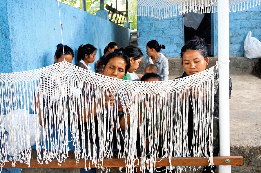 Muntigunung vilagers handweaving a hammock