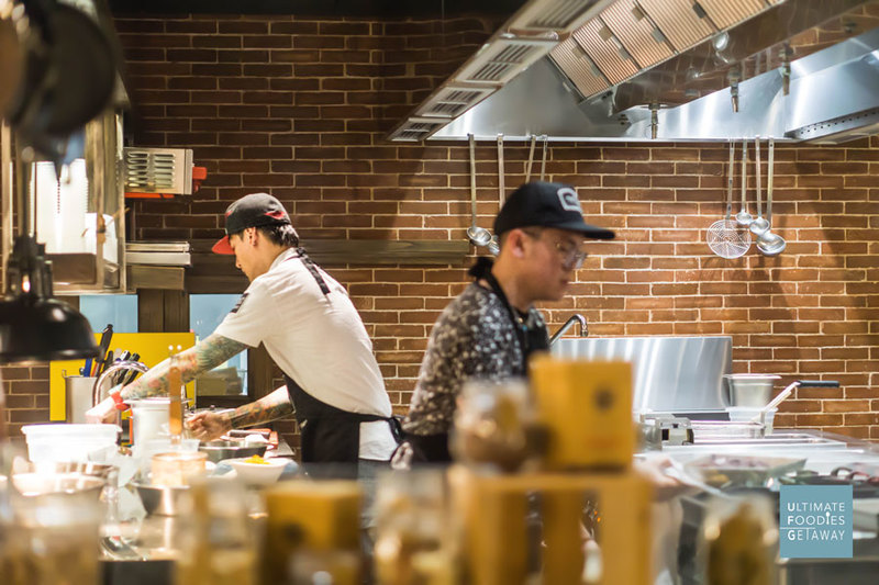 Chef Juna preps dishes for his team