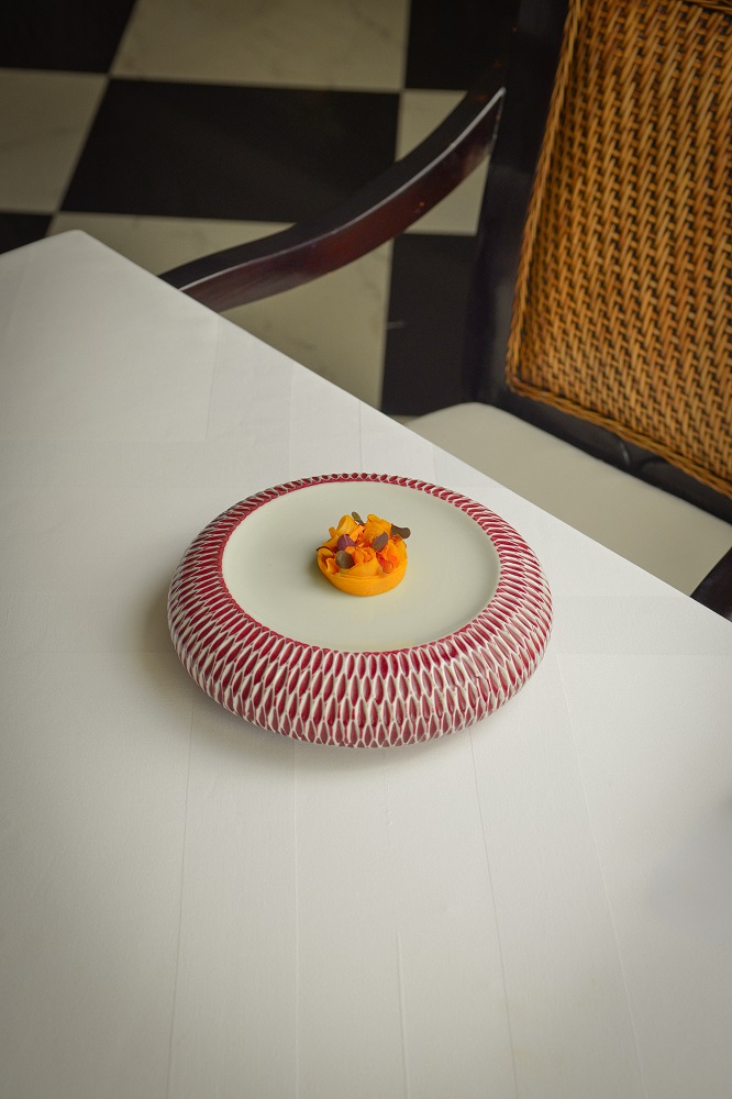Aperitif Restaurant 'Labu Emas,' pumpkin prepared three-ways (fermented, confit, and smoked), and gracefully presented to symbolise the marigold flowers used in offerings, the oils of which are also infused into the dish's sauce.