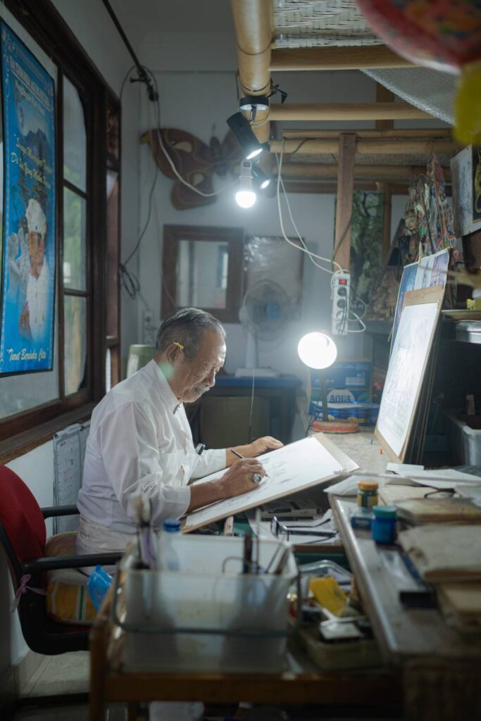 Gusti Nyoman Darta in the Ekalaya Tattwa Painting Studio, located on the upper level of his home.